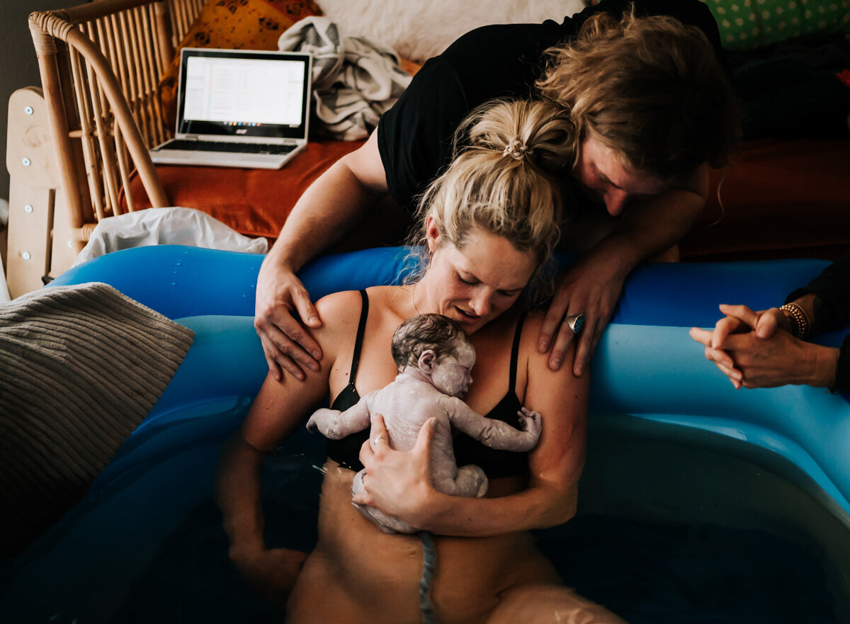 An intimate moment of skin-to-skin contact between parent and baby, capturing the warmth and closeness that promotes bonding right after birth.
