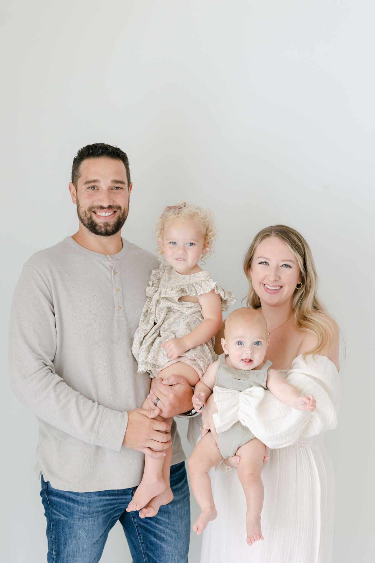 parents holding their two small kids