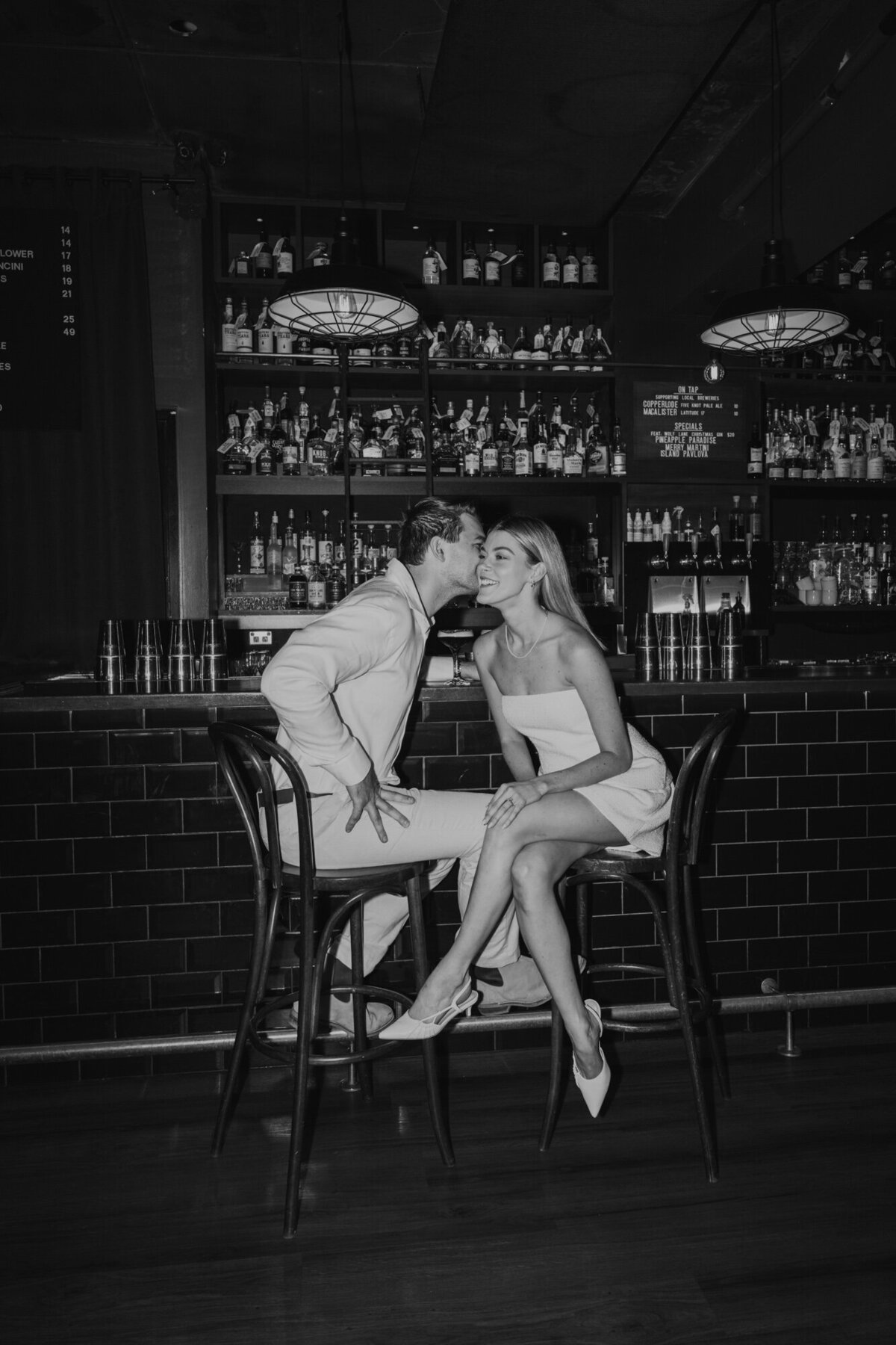 flash photo of engaged couple in cairns bar