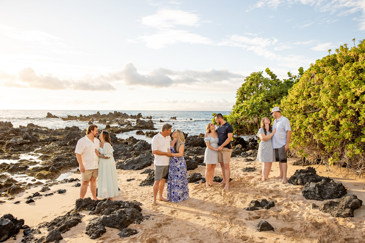 Maui Family Photographers capture couple standing together on beach embracing