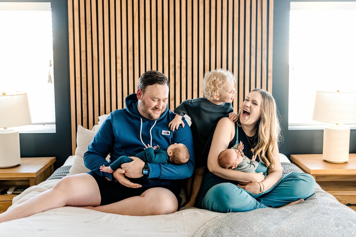 family-laughing-on-the-bed