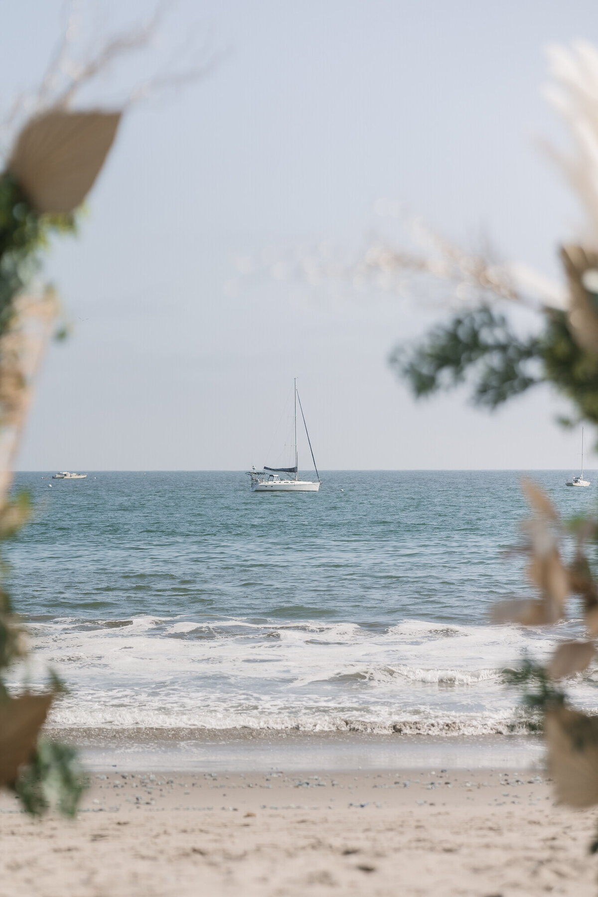 Sailboat on ocean in distance at Hilton Beachfront Resort Santa Barbara