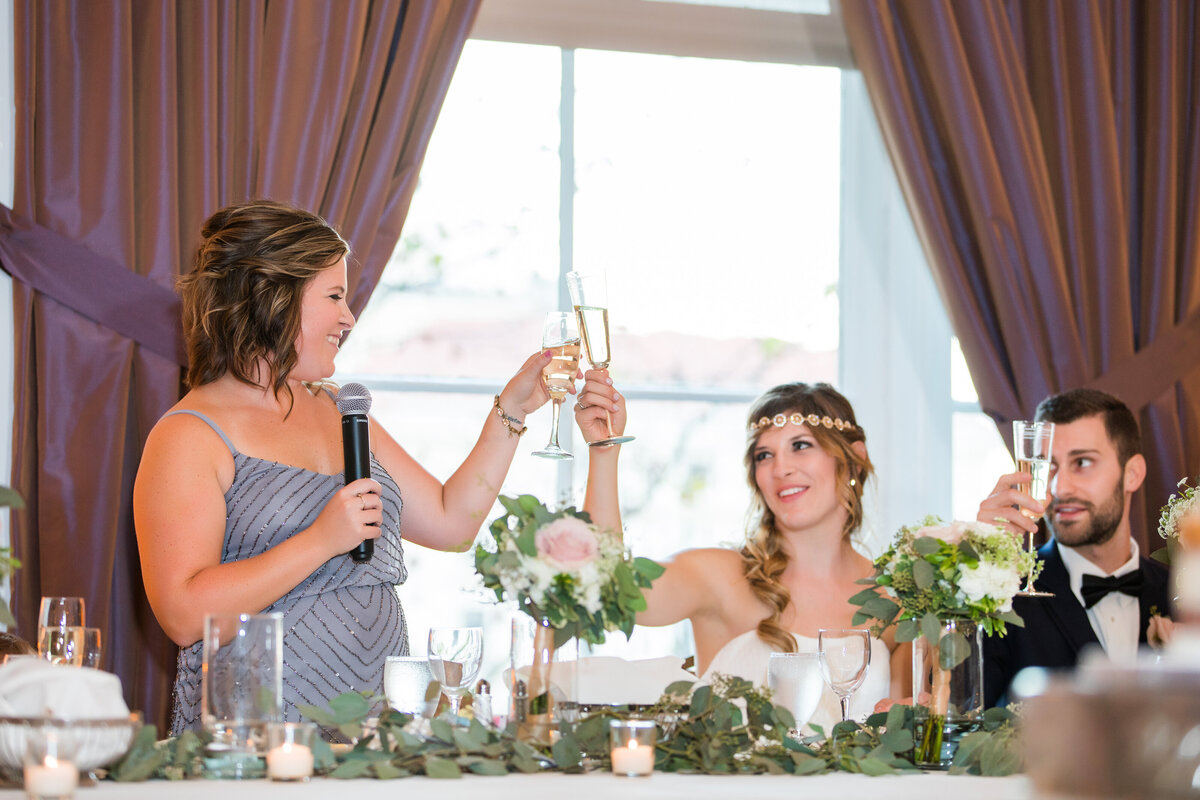 bride toasting with her maid of honor at university club wedding