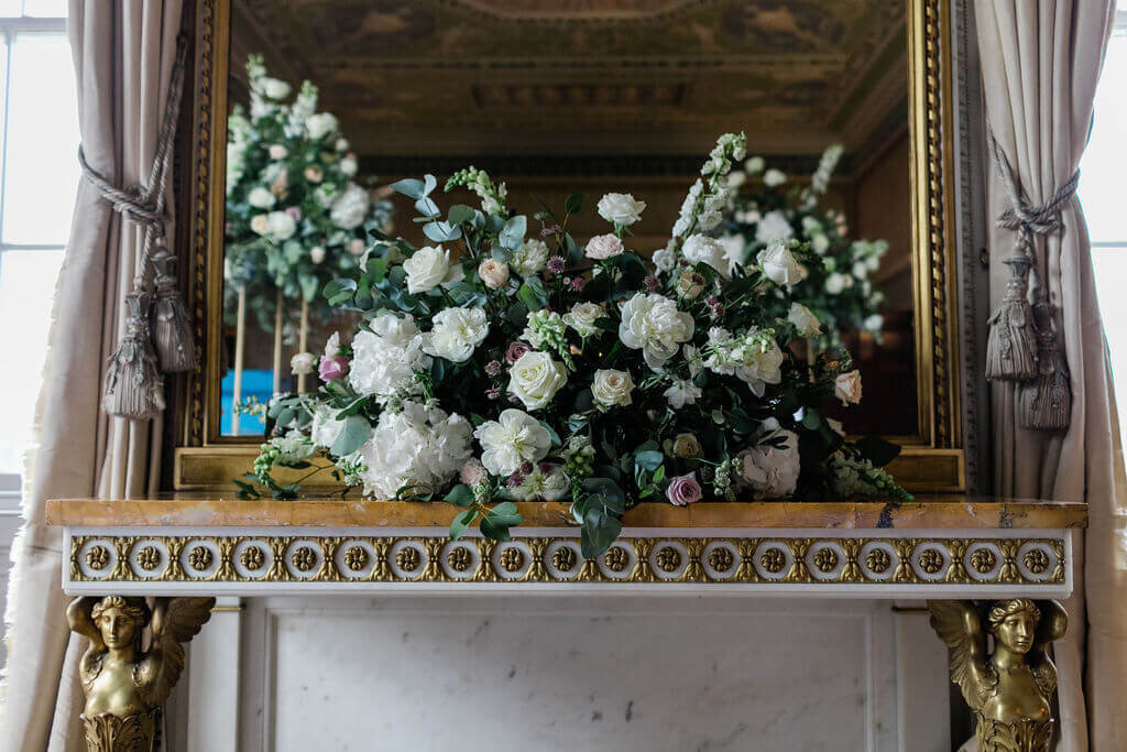 Beautiful mantlepeice adorned with flowers by Wildflower and Willow