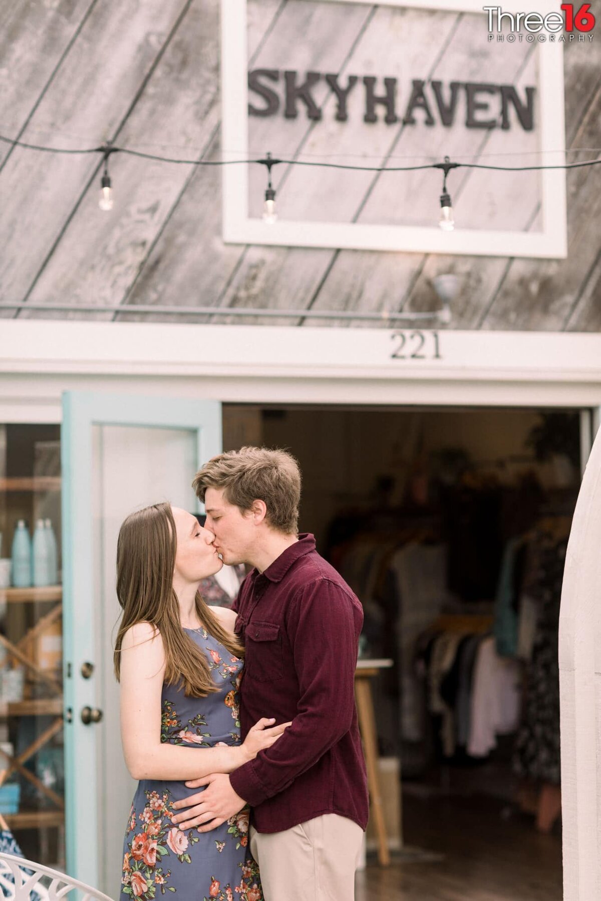 Romantic kiss between engaged couple in Downtown Balboa Island