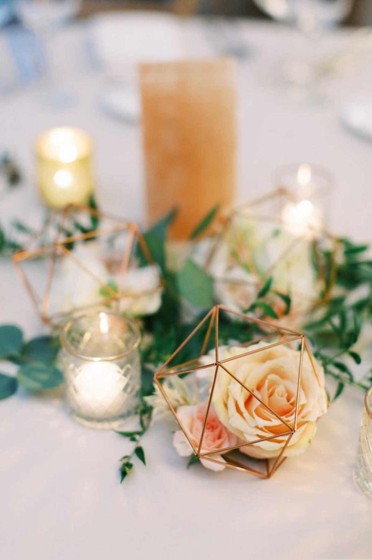 Geometric gold floral centerpieces with pink Himalayan sea salt table numbers at a luxury Chicago outdoor garden wedding.