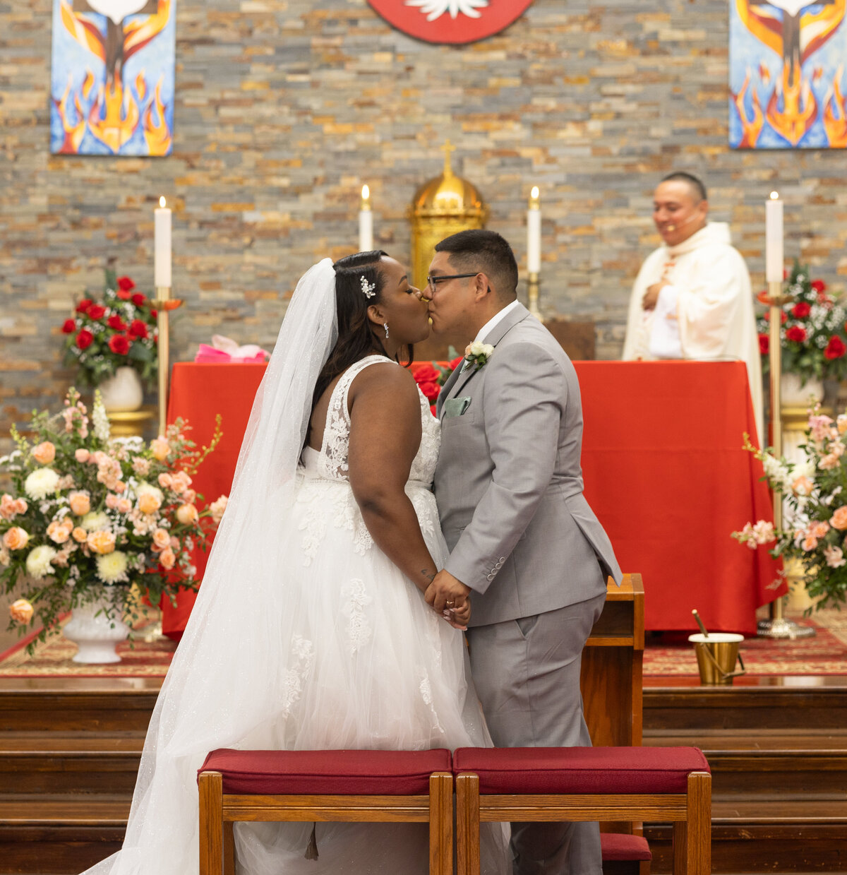 bride and groom first kiss at Catholic church in Alexandria Virginia by Washington DC wedding photographer Amanda Richardson Photography
