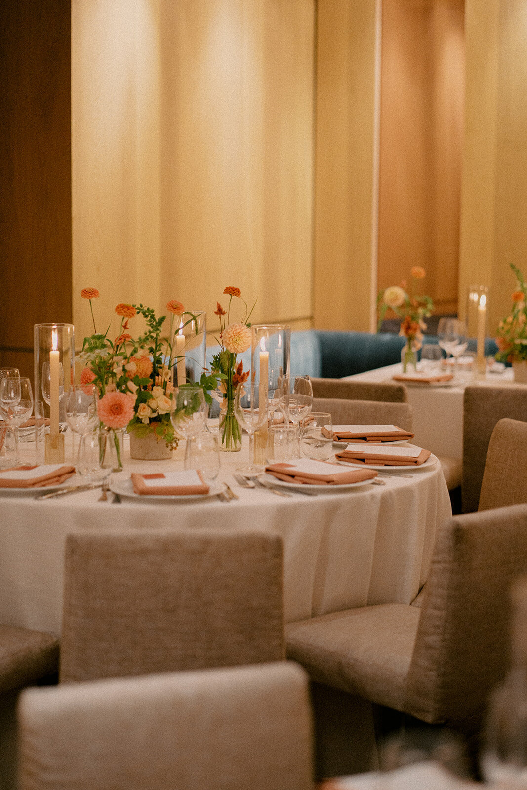 Medium centrepieces of peach garden flowers at a Restaurant Beatrice wedding reception.
