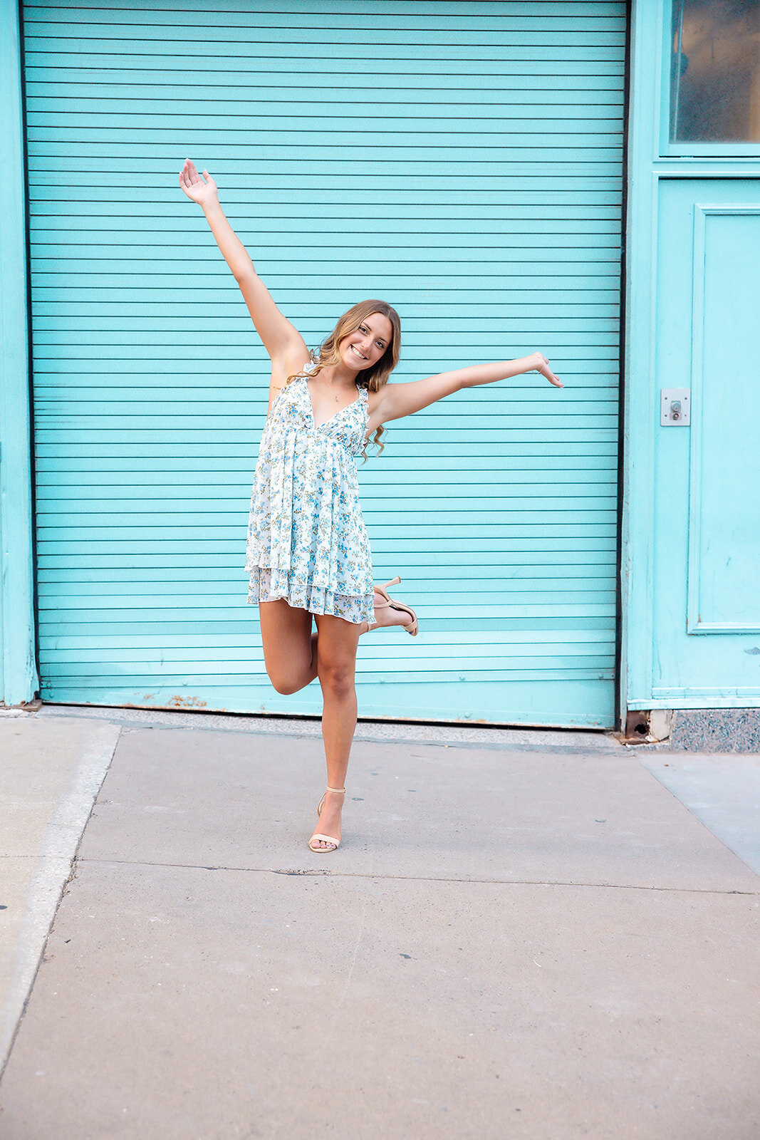 Senior girl excited on blue background at power and light