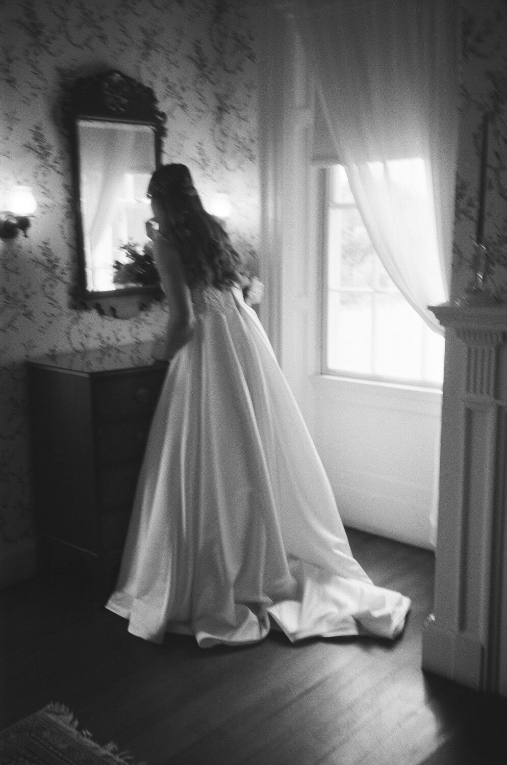Black and white photo of the bride preparing