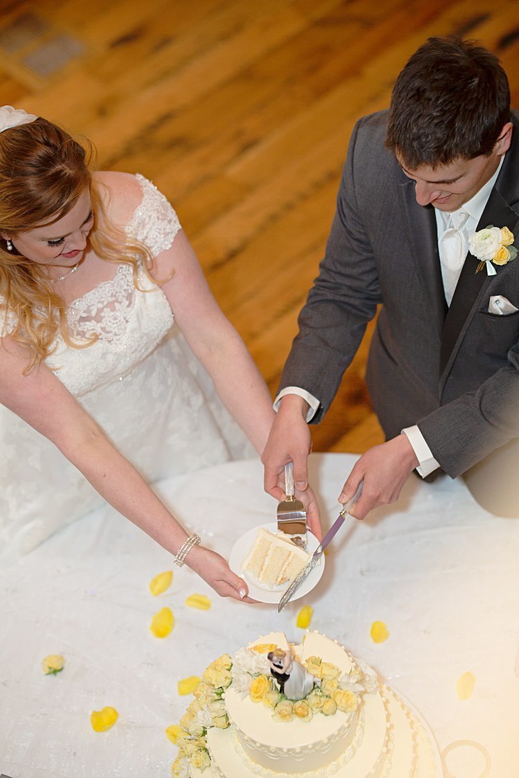 Image of Bride and Groom cutting wedding cake shot from above