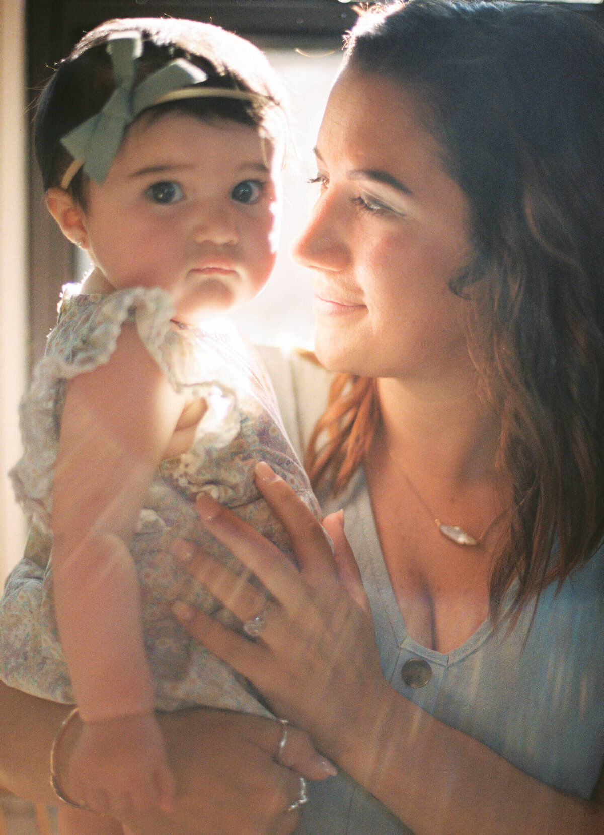 mother and child in beautiful light indoor 35mm film