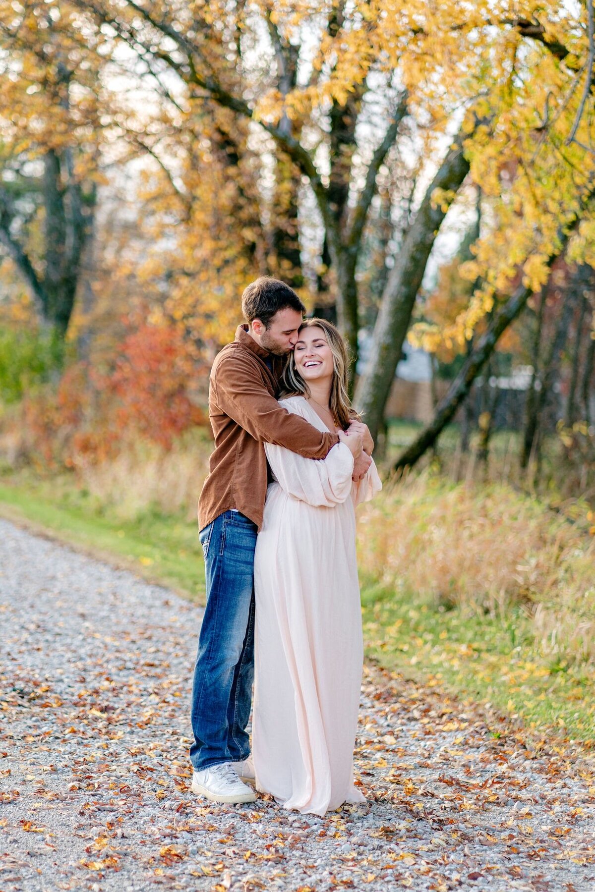 groom-kissing-bride-smiling-fall