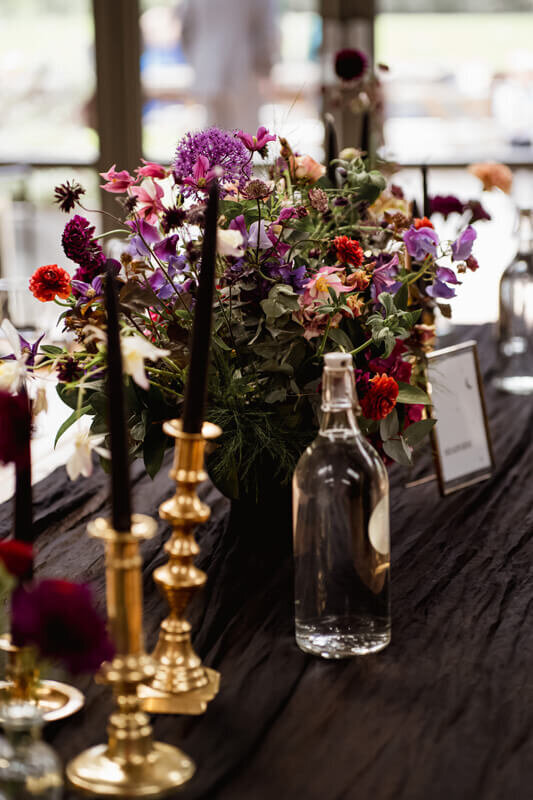 Gothic deep vibrant wedding table flowers by the little flower hut