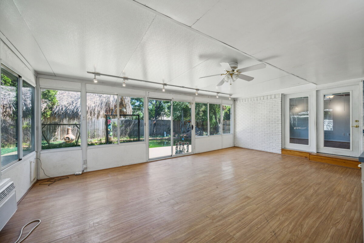 sunroom_edgecrest_dallas_tx_white_brick_and_windows_with_backyard_view_-_real_estate_by_haven_group