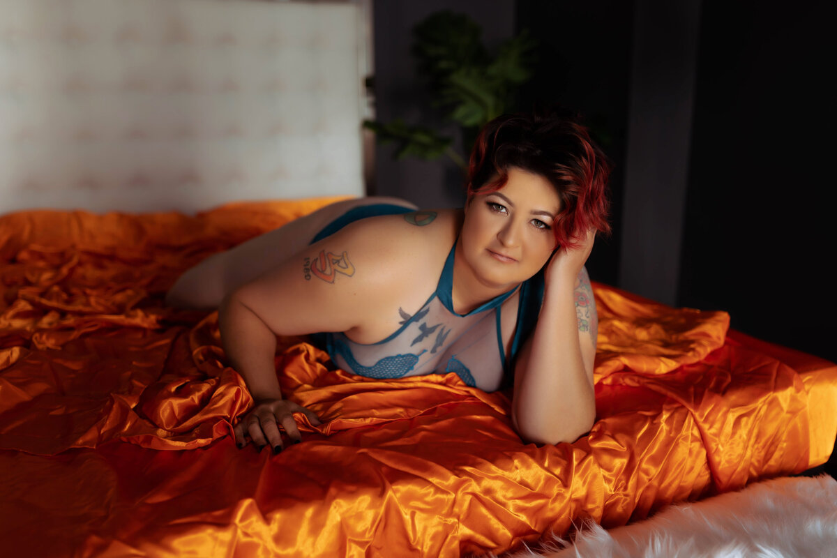redhead woman in blue lingerie on orange sheets elkridge