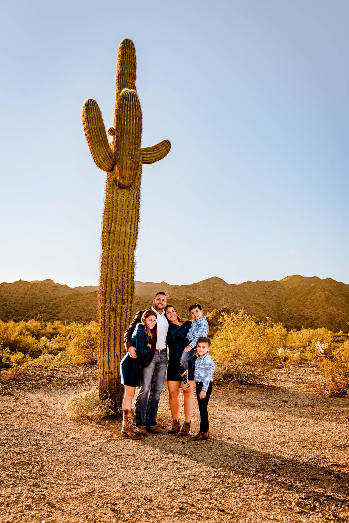 Arizona saguaro with family posing for photographs