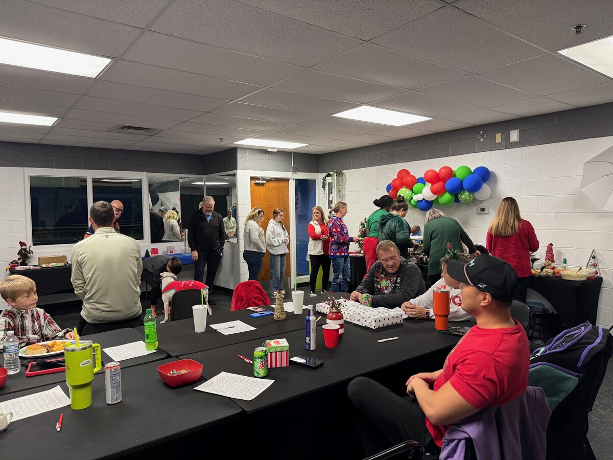 A cozy scene of friends and family connecting over snacks and drinks in the party room, showcasing the venue’s welcoming atmosphere.