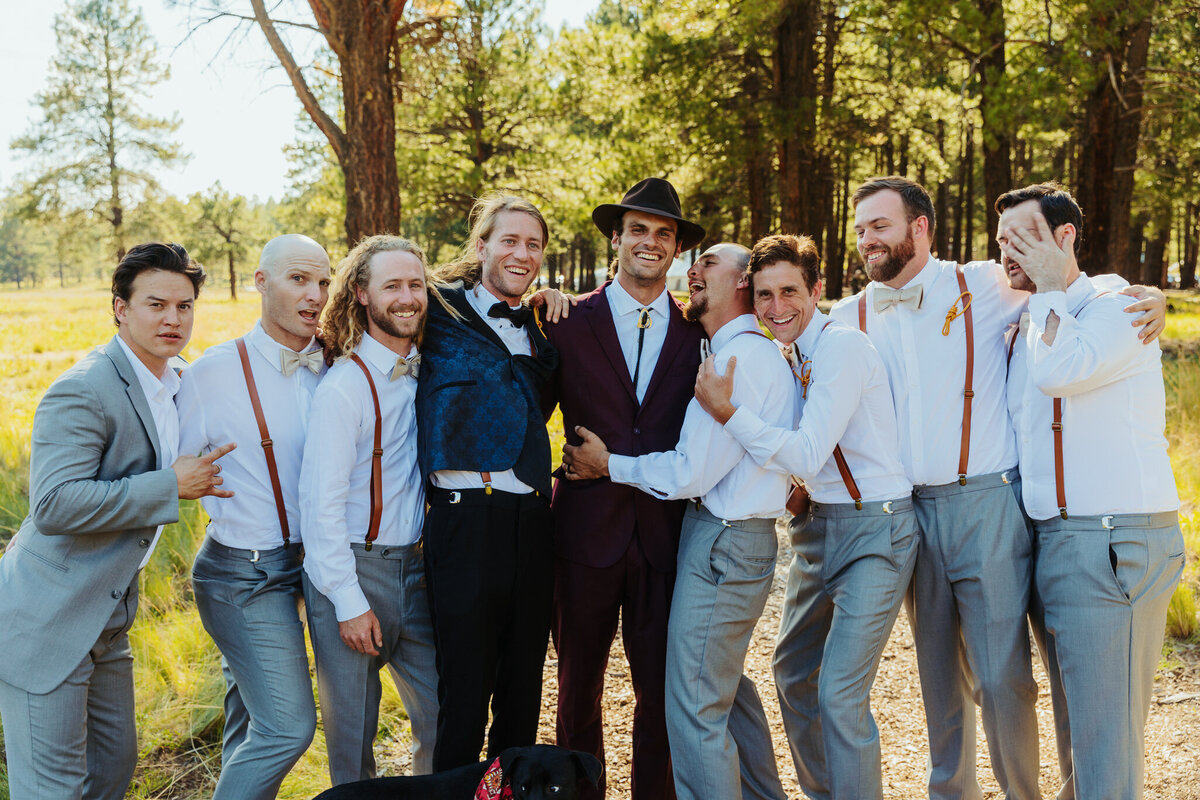 groomsmen climing and having fun for the photo