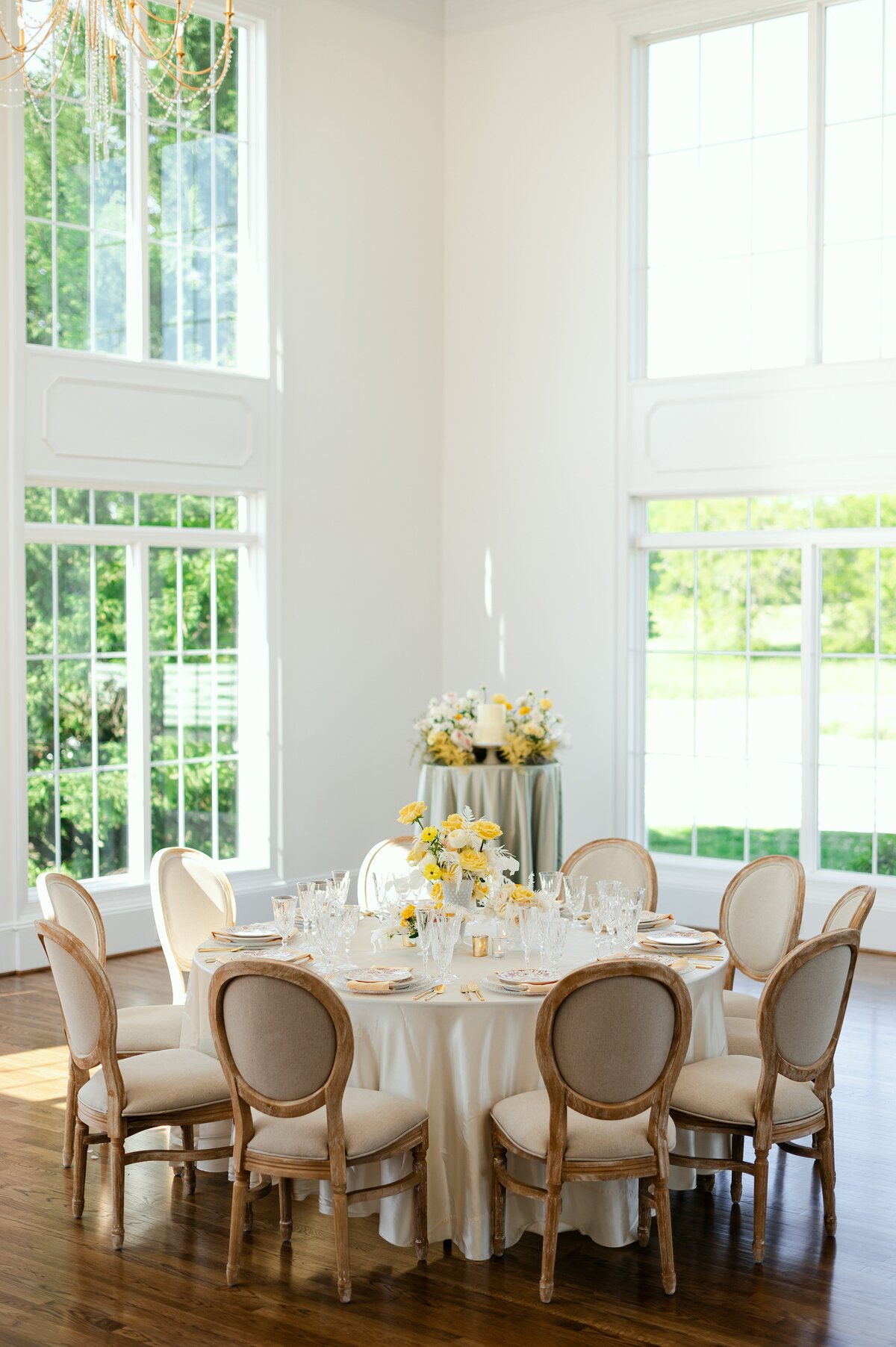 Round tables set in the two-story Estate Ballroom