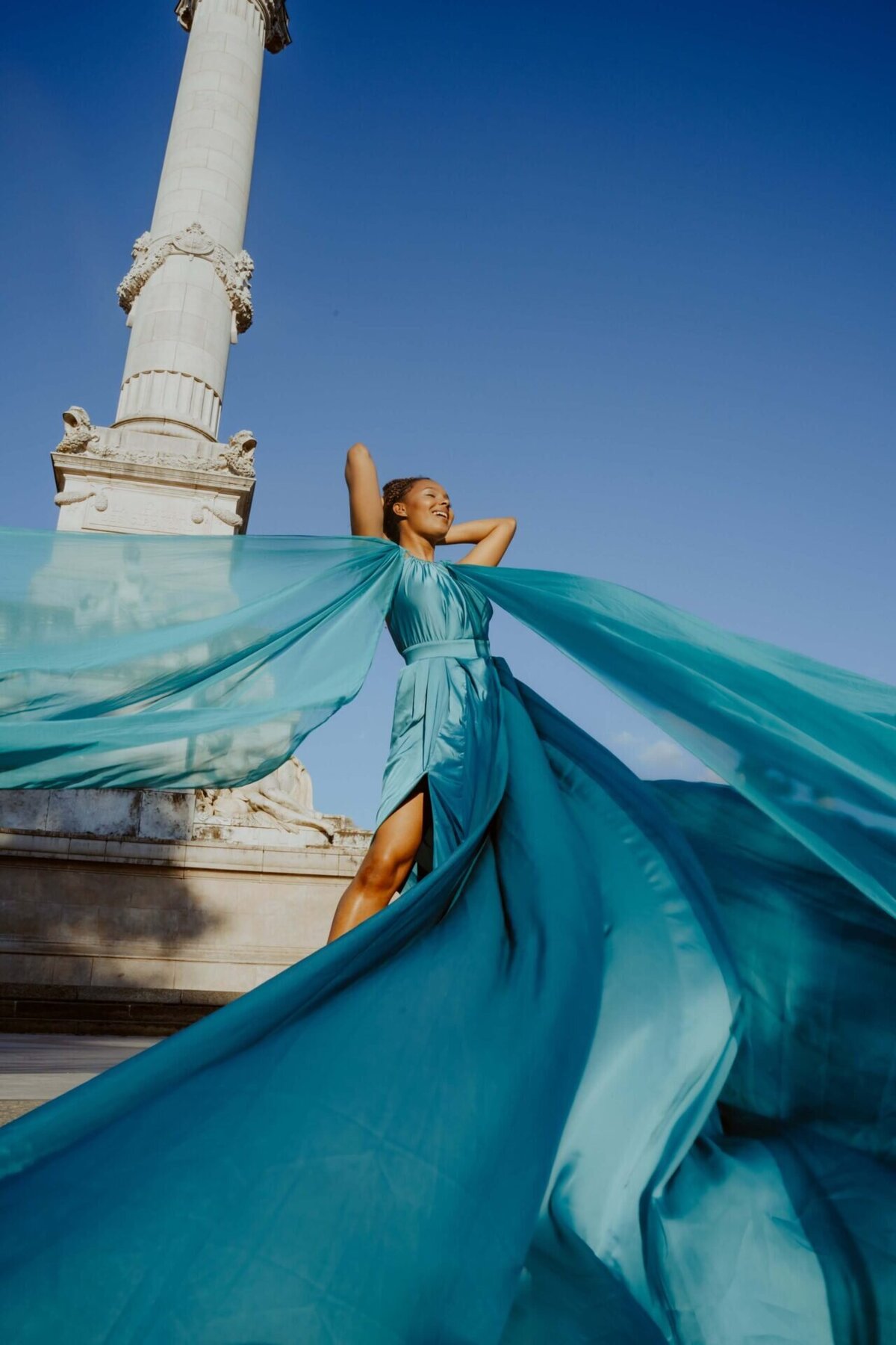 women having a portrait photoshoot in paris wearing a blue flying dress