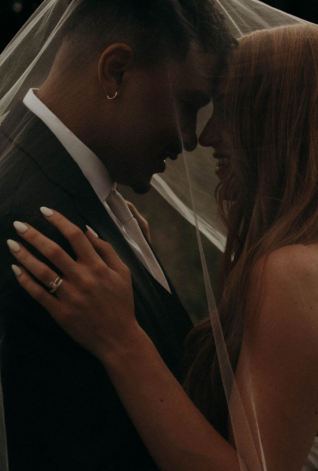 moody bride and groom portrait interracial couple