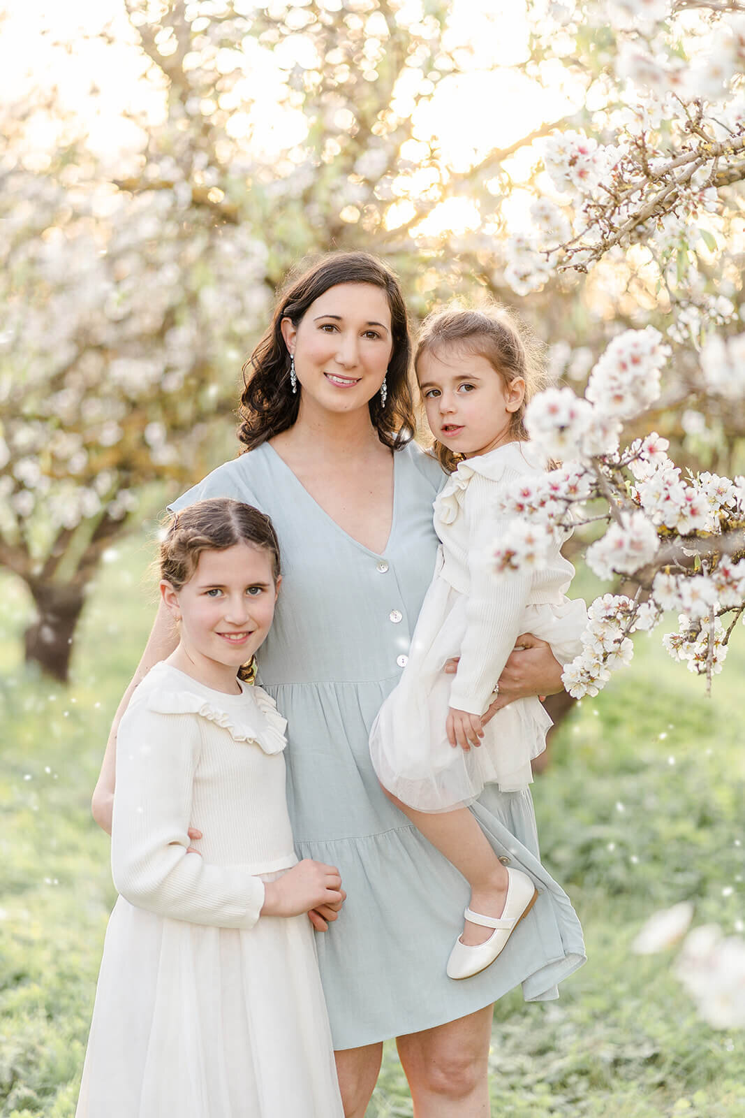 Nature's gift: Family portrait amidst blooming plum blossoms in Brisbane's springtime