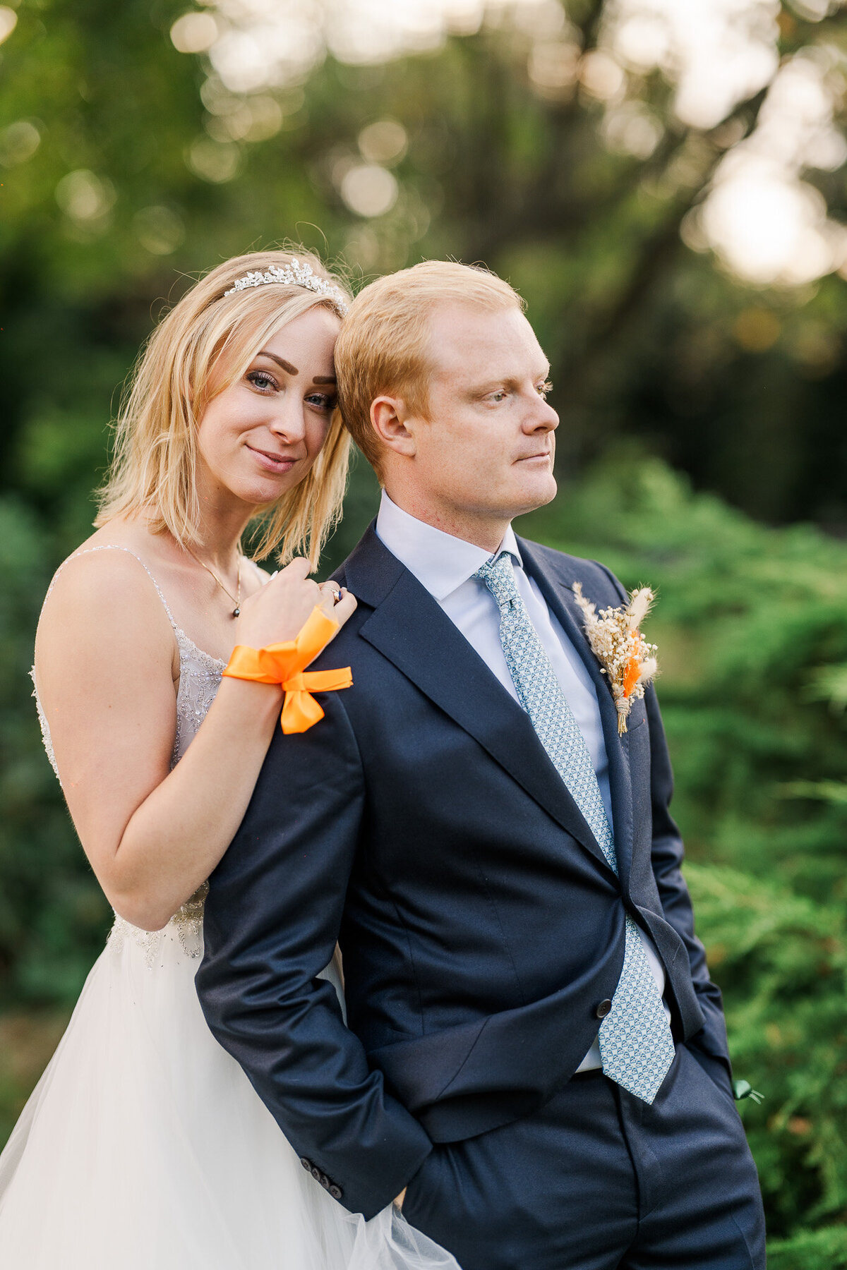A bride and groom pose for portraits after their september garden wedding in Heerle