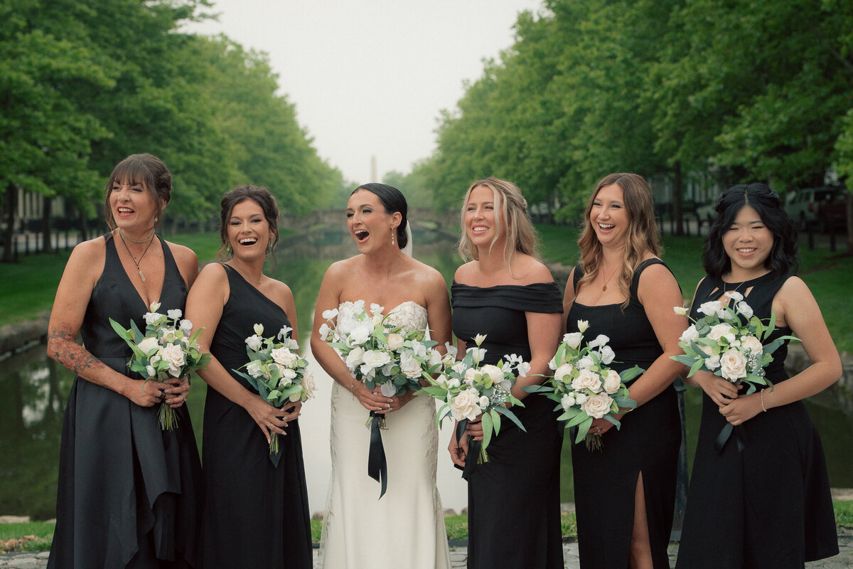 Close-up of bridesmaids and bride holding bouquets