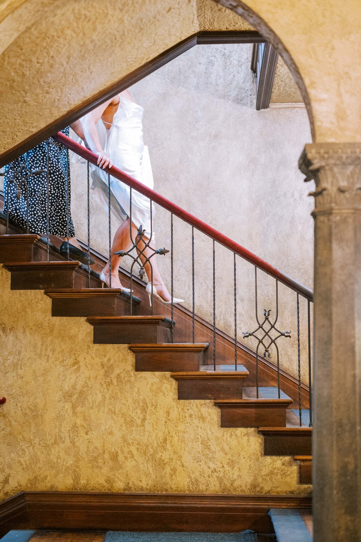 bride-in-white-heels-walking-down-stairs