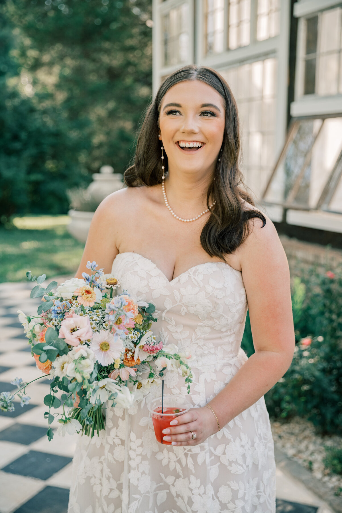 Three Oaks Manor Wedding | bride holds bouquet and signature cocktail