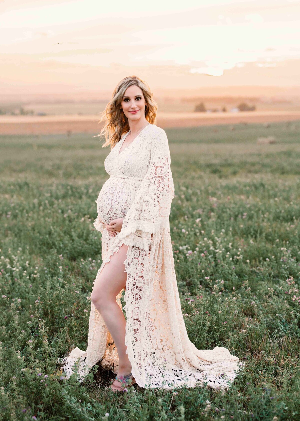 Pregnant Mother to be in a field in a white boho gown
