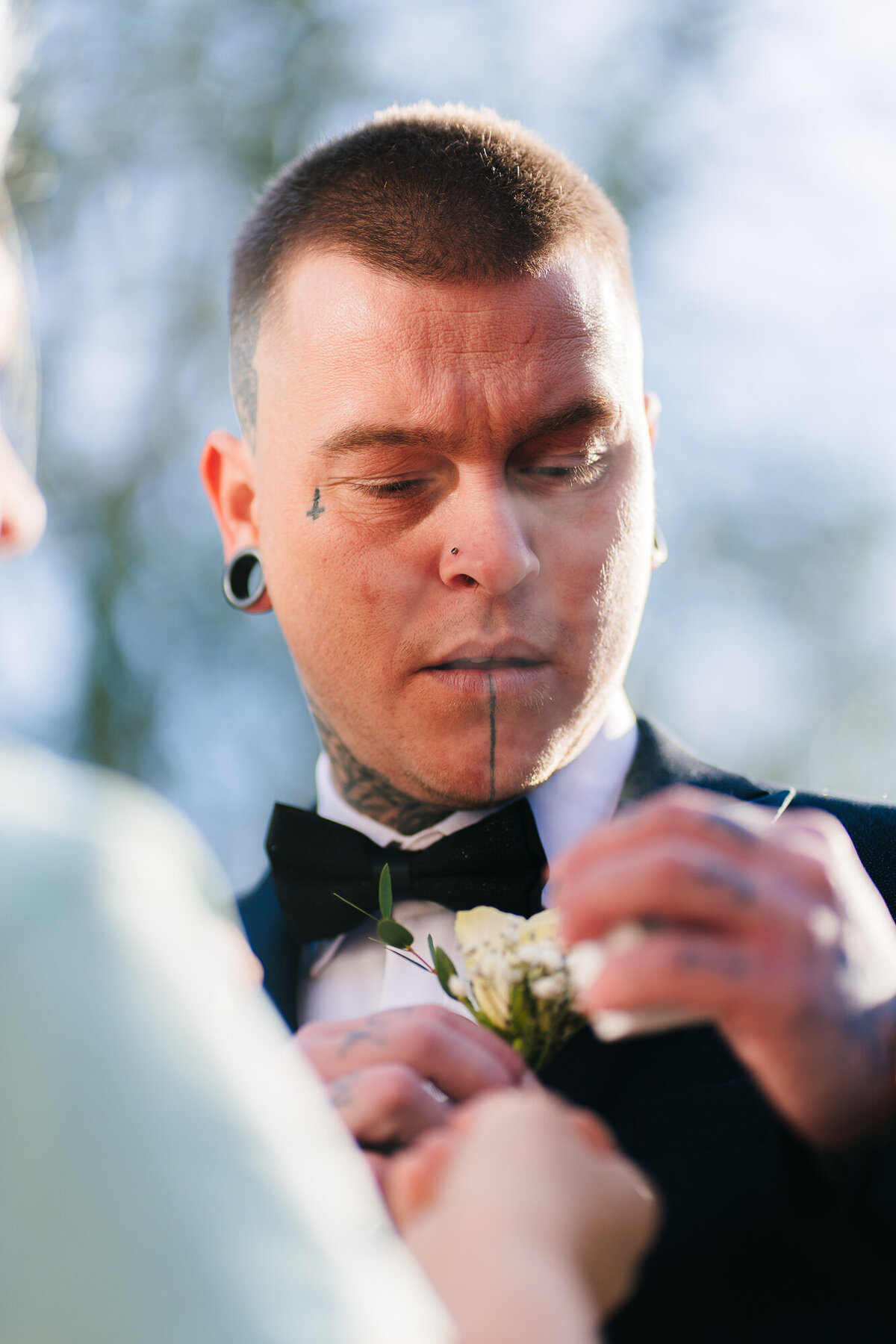 Grooms mother putting grooms button hole taken at Ashfiled House by Wedding photographer Anthony Horseman