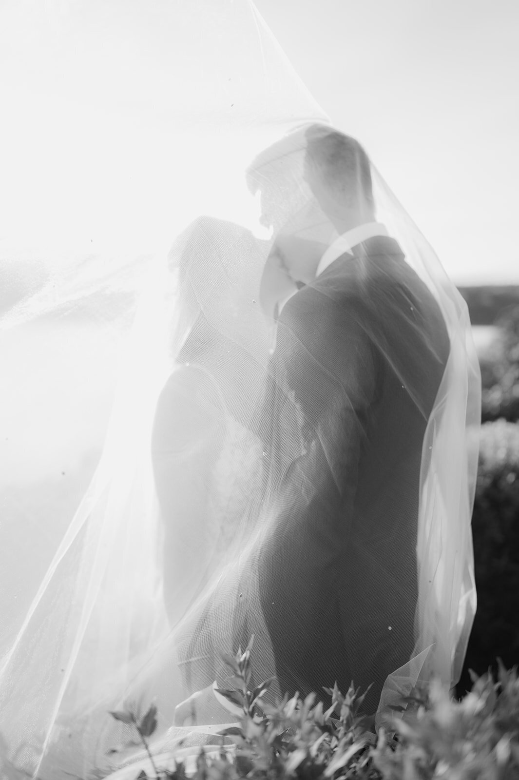 bride and groom share a moment suring sunset by the mid hudson bridge, poughkeepsie ny