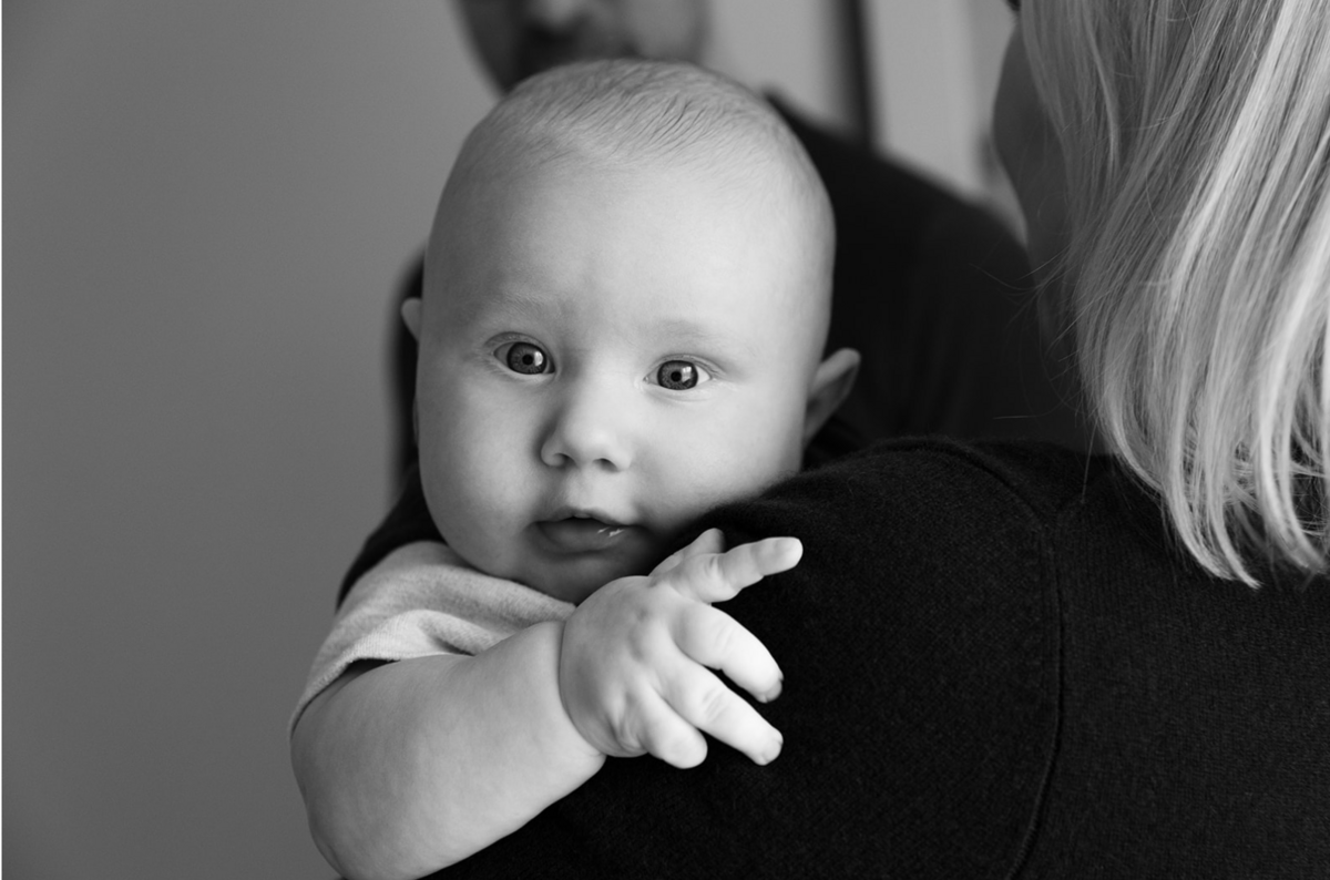 Curious newborn baby during in-home lifestyle photo session.