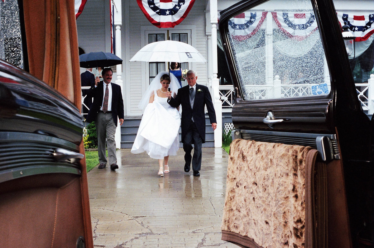 bride escorted to car by dad
