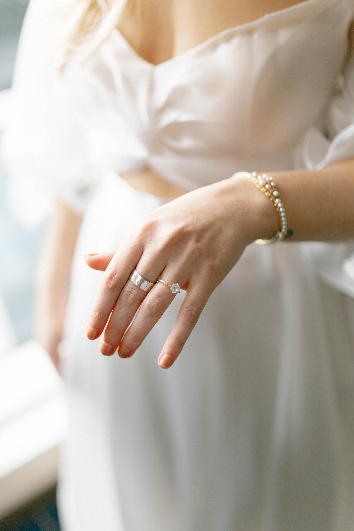 Brides hand showing off jewelry at the 101 in Seattle.