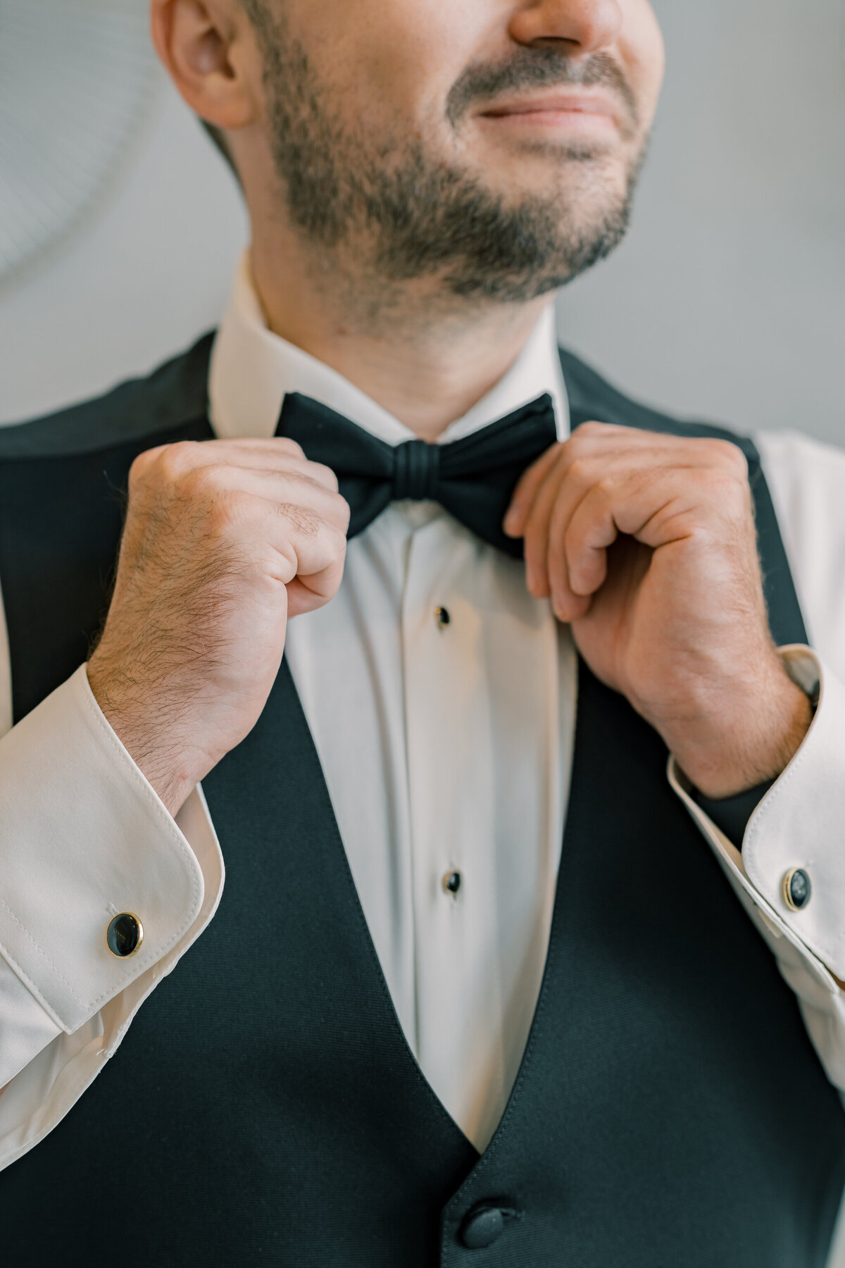 Bristol Hotel Wedding | closeup of groom adjusting his bow tie