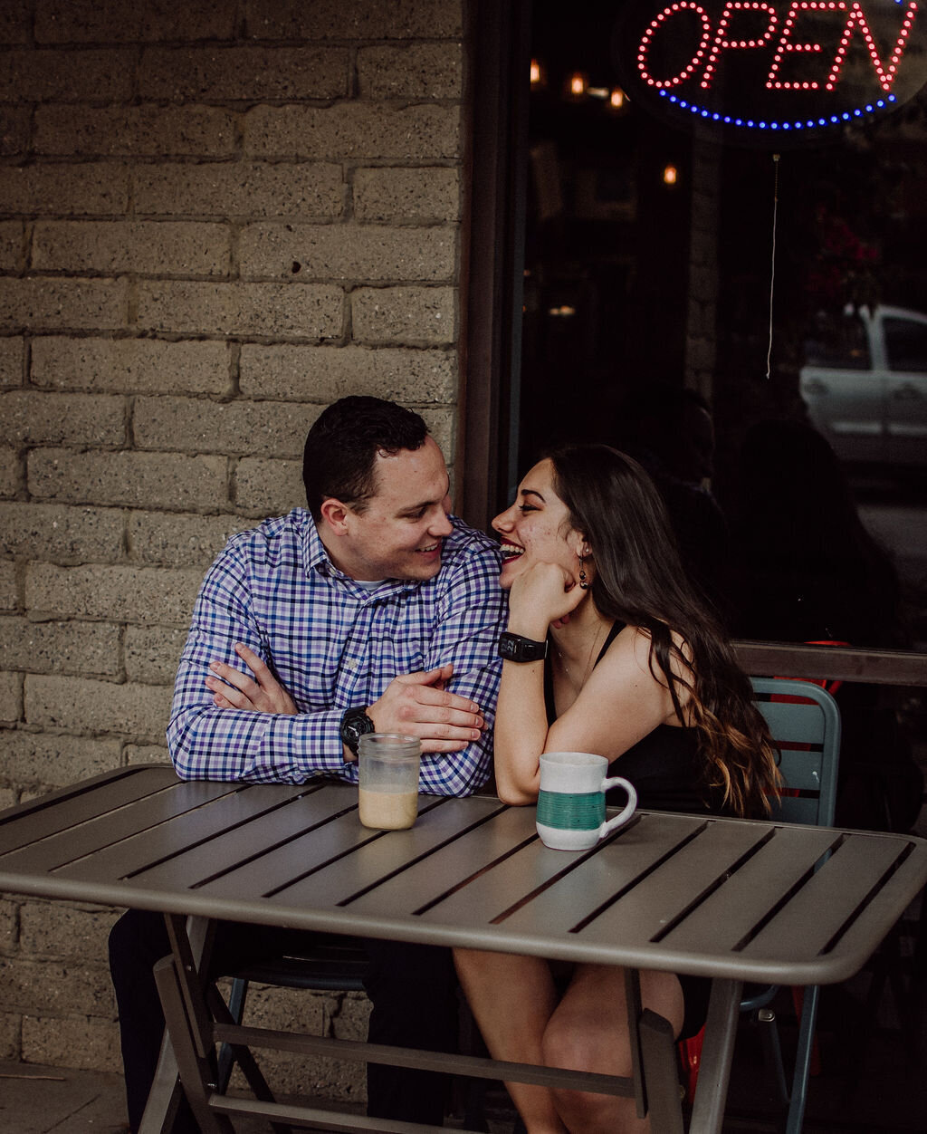 photographer and husband laughing while drinking coffee in Phoenix