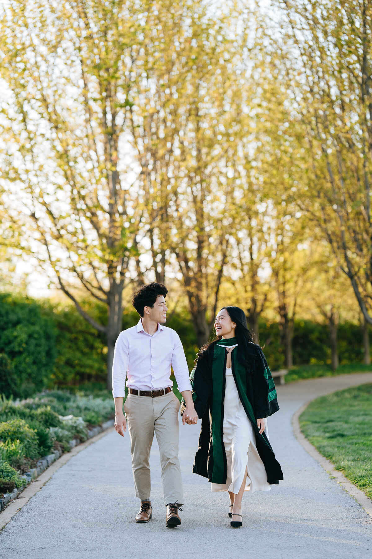 slu grad with boyfriend walking and holding hands