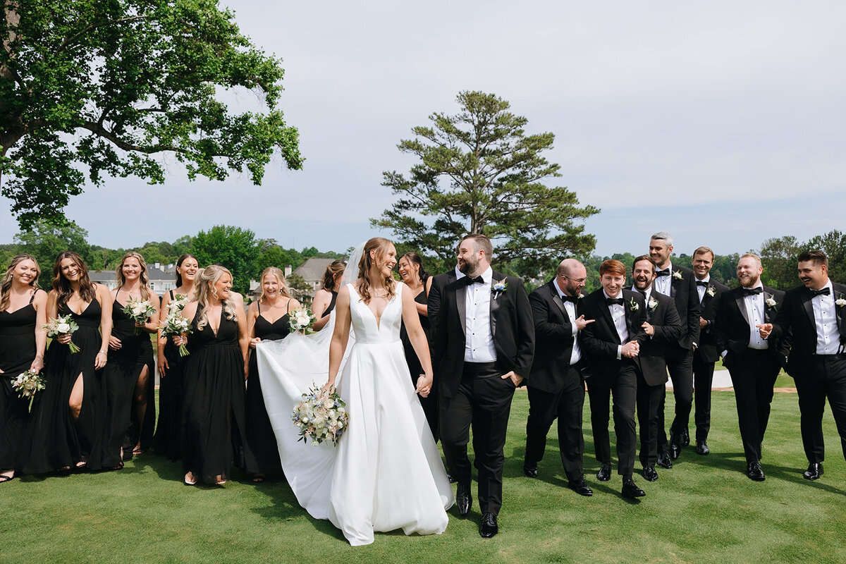 Wedding party walking together at TPC Sugarloaf in Duluth, Georgia.