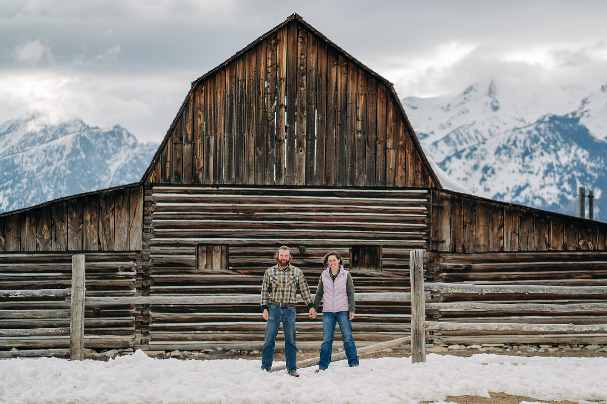 Couple standing in front of the Moulton Barn