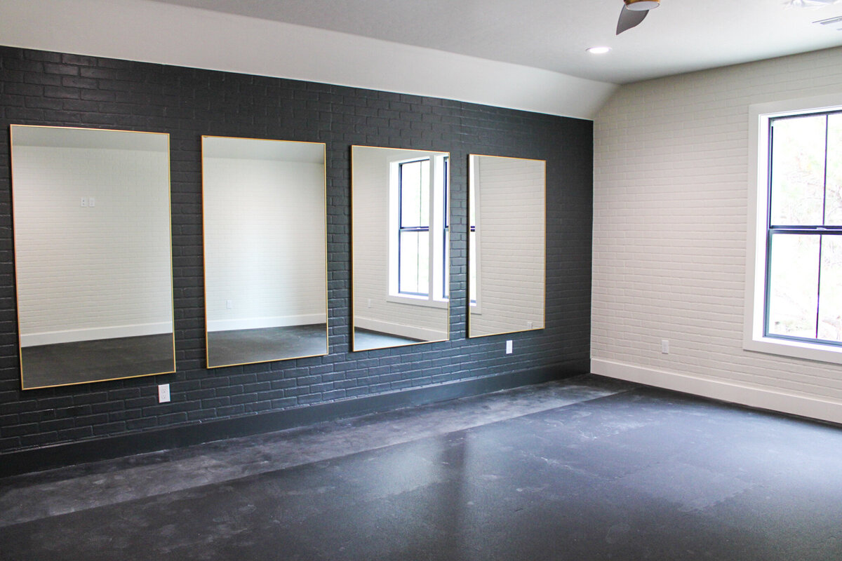 empty living space with black floors in process of being built