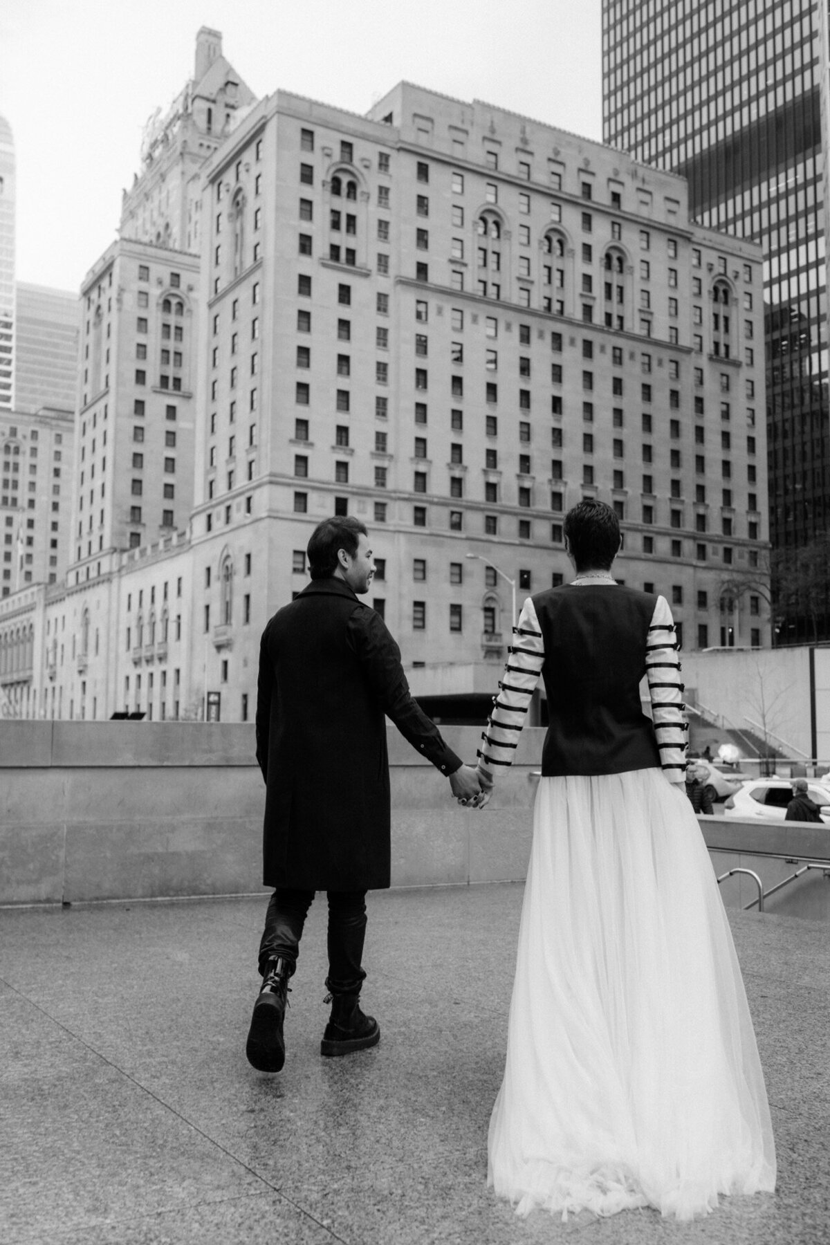 LGBTQ couple holding hands and walking toward the crowd at Union Station, Toronto