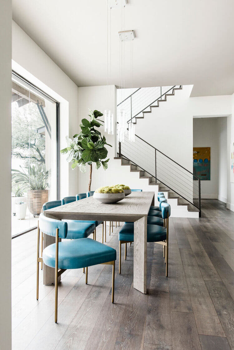 oyster creek studios austin barton creek turquoise leather chairs around a wooden dining room table with succulents
