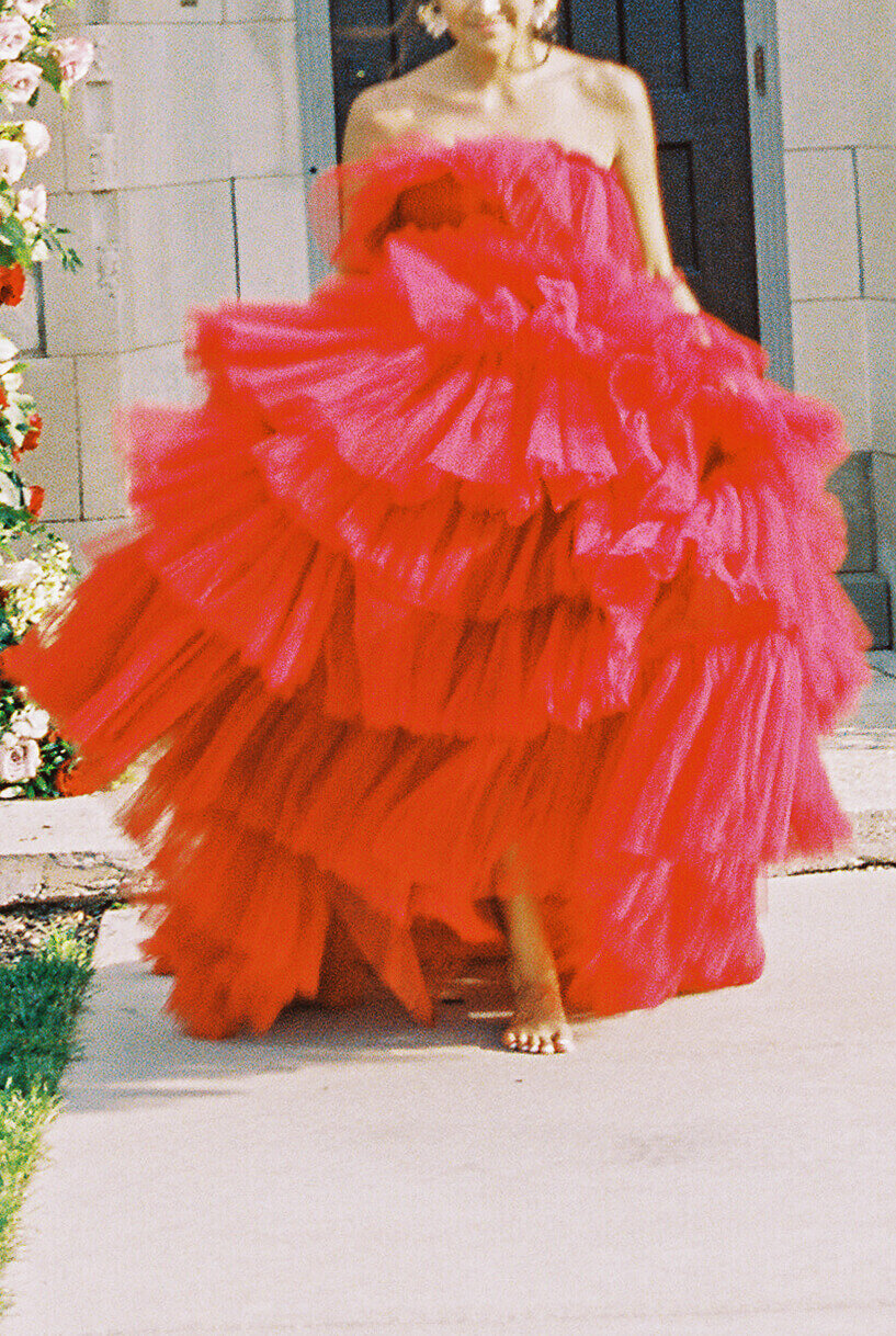 bride in puffy red tulle wedding dress walking