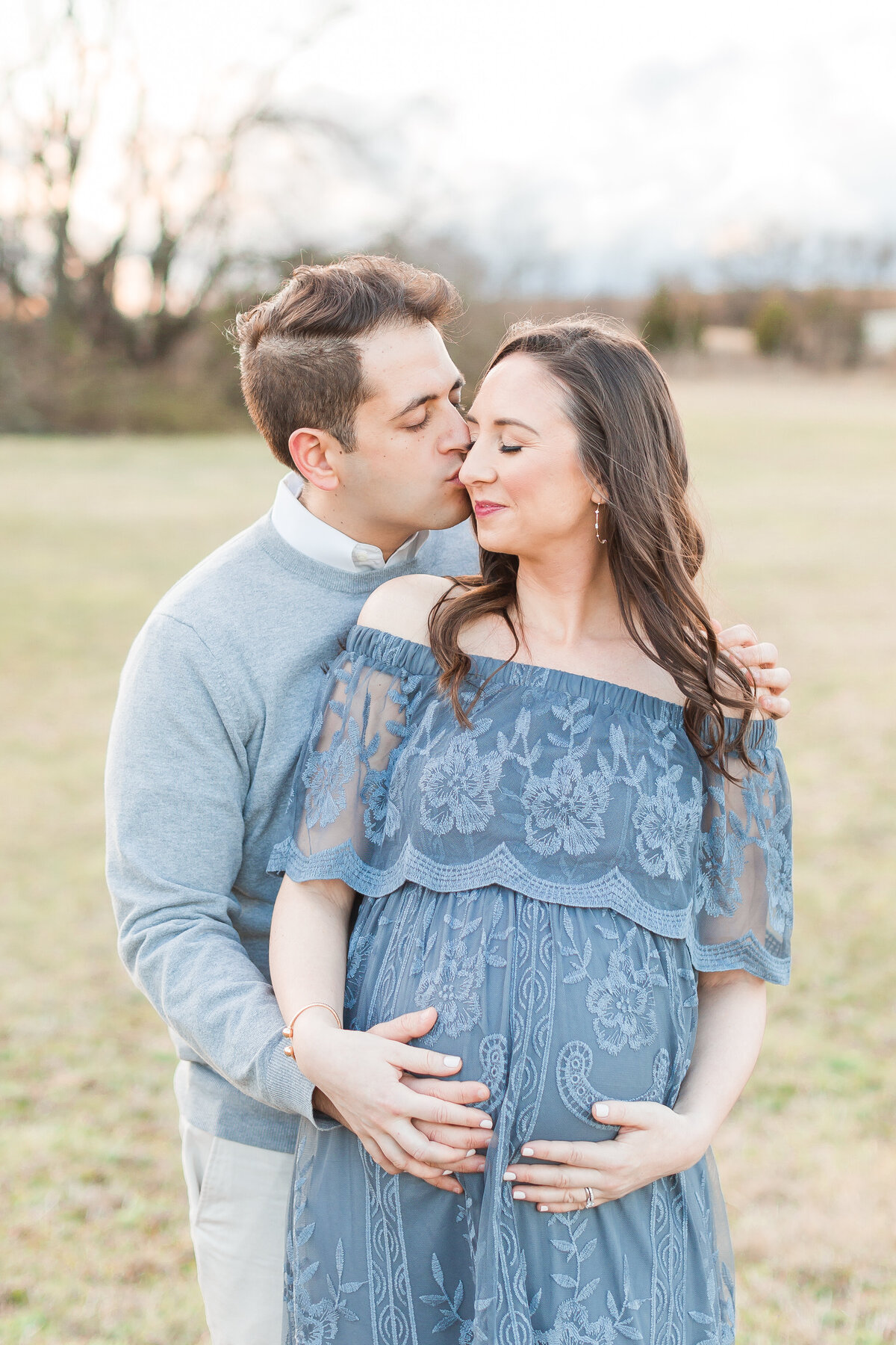 An outdoor photo of a couple embracing by DC Maternity Photographer
