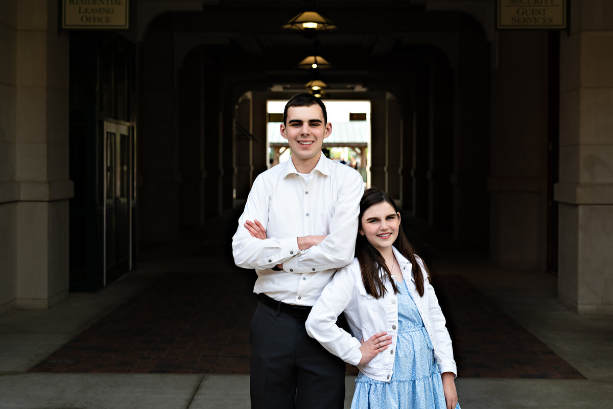 A brother and sister pose together for family photos in downtown Huntsville