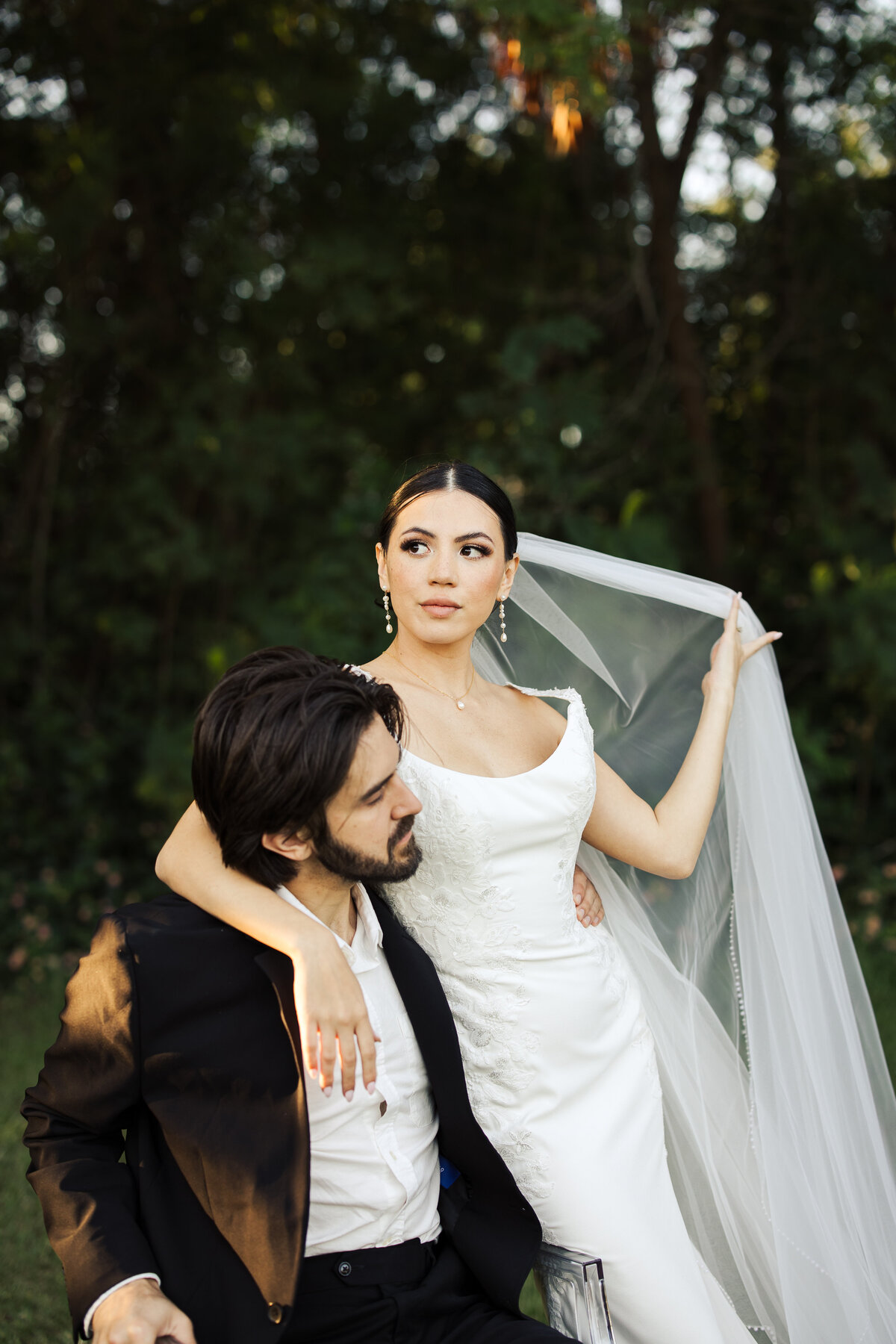 Editorial bride and groom image with accents from the veil