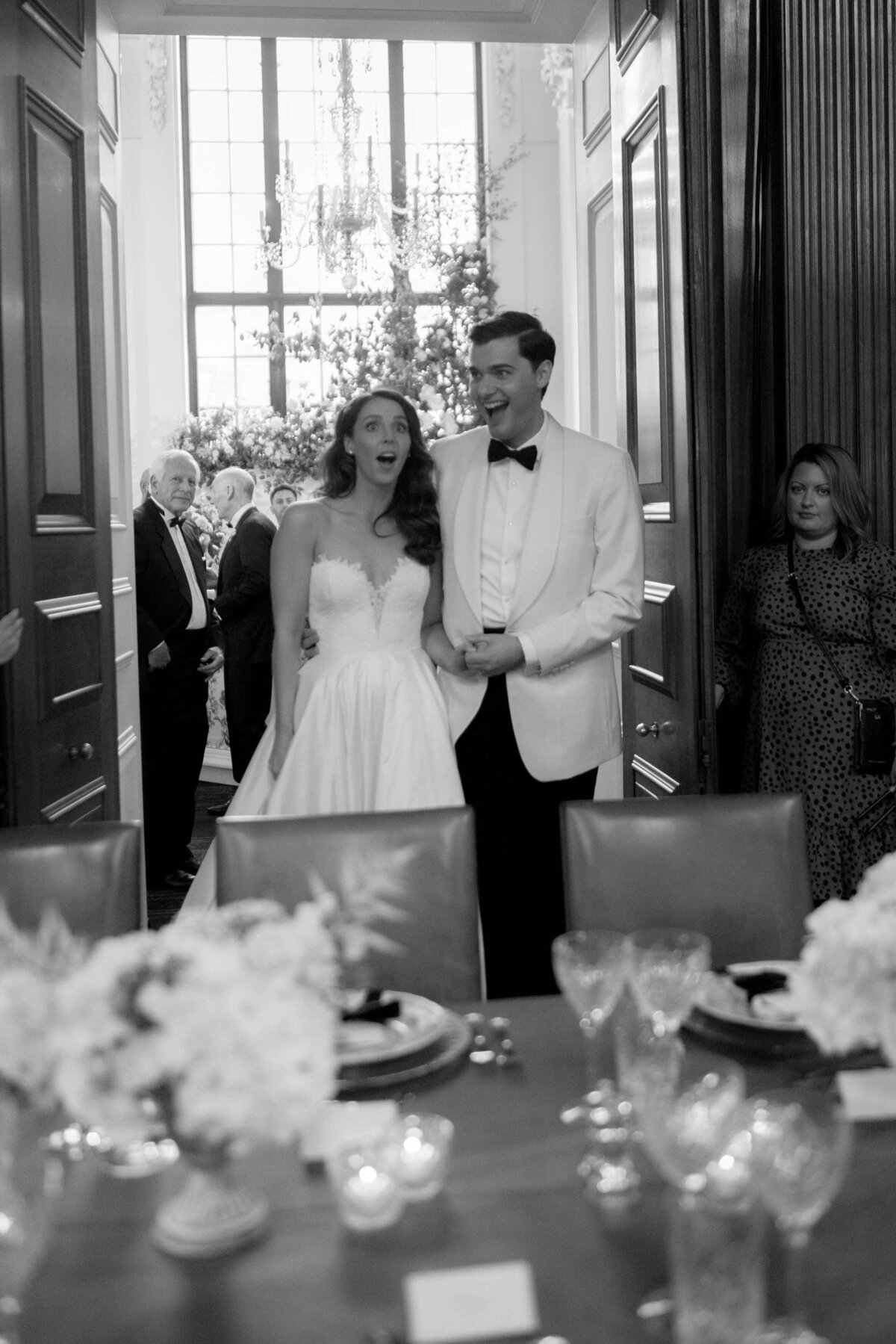 bride and groom gasp in delight as they walk into their wedding dinner for the first time and see their wedding design in the ballroom of the ned hotel london